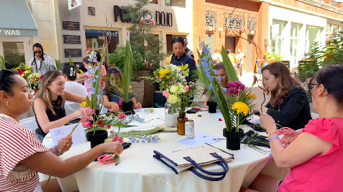 Outdoor Ikebana workshop participants arranging flowers at Bethesda Row